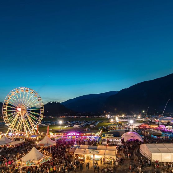 Bunt beleuchtetes Gelände in der Abendstimmung am Internationalen Trucker & Country-Festival