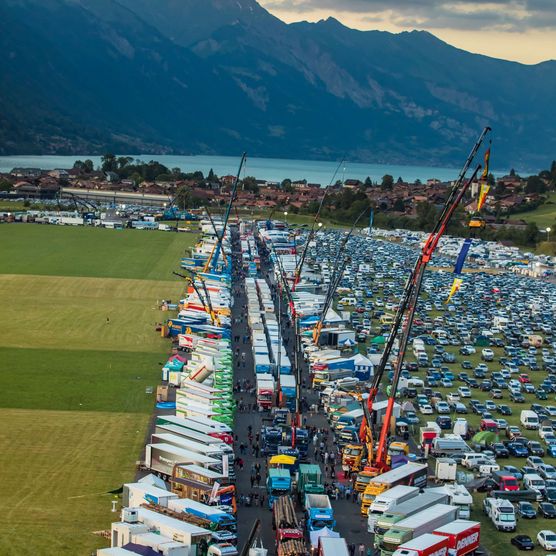 Lastwagen entlang der Truck Meile und im Hintergrund der Brienzersee und die Berge