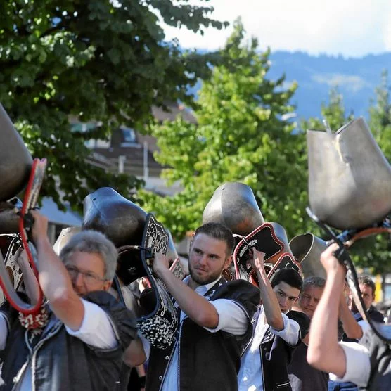 Trychler laufen mit schwingenden Schweizer Glocken durch Interlaken